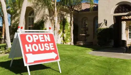 How to Find Buyers in Real Estate (Without Wasting Time on Duds) 5 "Open House" sign in front of a welcoming, sunny home, inviting potential buyers and showcasing a lead generation opportunity for agents.