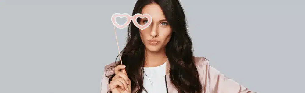 Real Estate Buyer Agent Consultation: Secrets to Win in 2025 6 A buyer agent holding heart-shaped glasses, symbolizing enthusiasm and readiness for a buyer agent appointment.